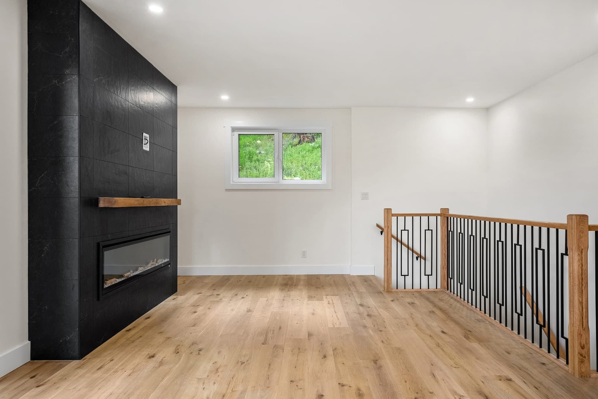 Open great room with feature fireplace and oak flooring