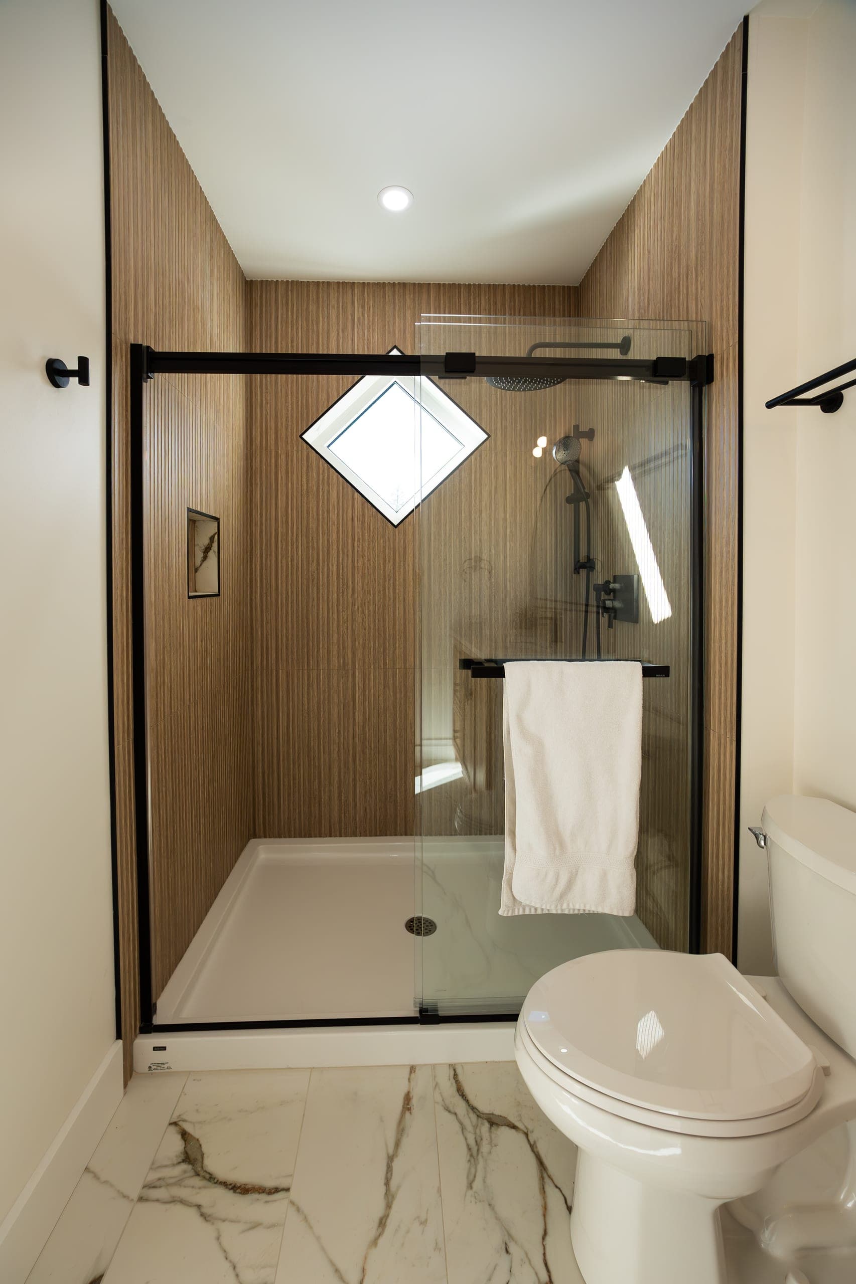 Spa shower with diamond skylight and fluted wood panel