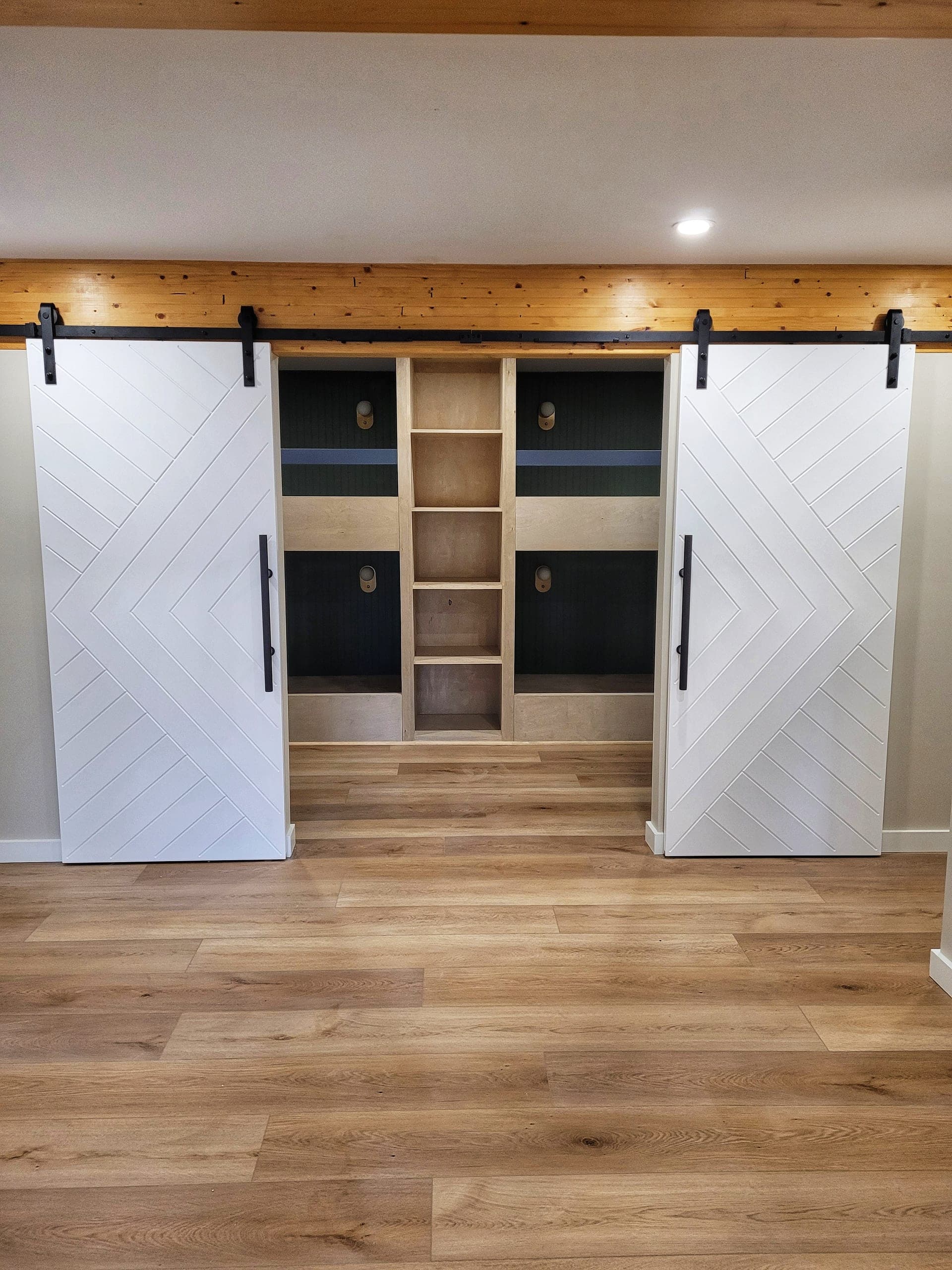 Bunkroom with custom chevron sliding barn doors