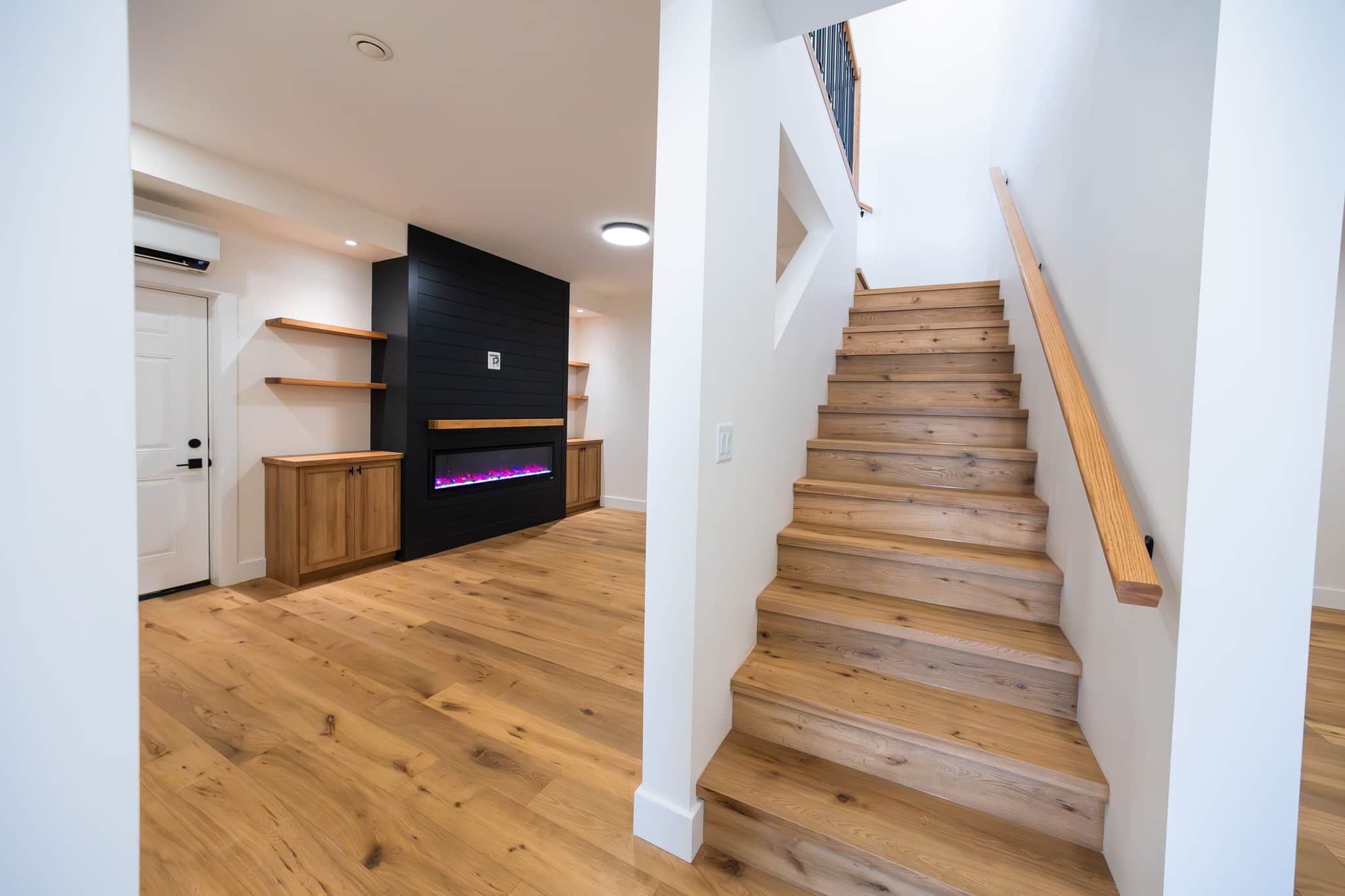 Basement great room with shiplap fireplace — recent Alpine View build