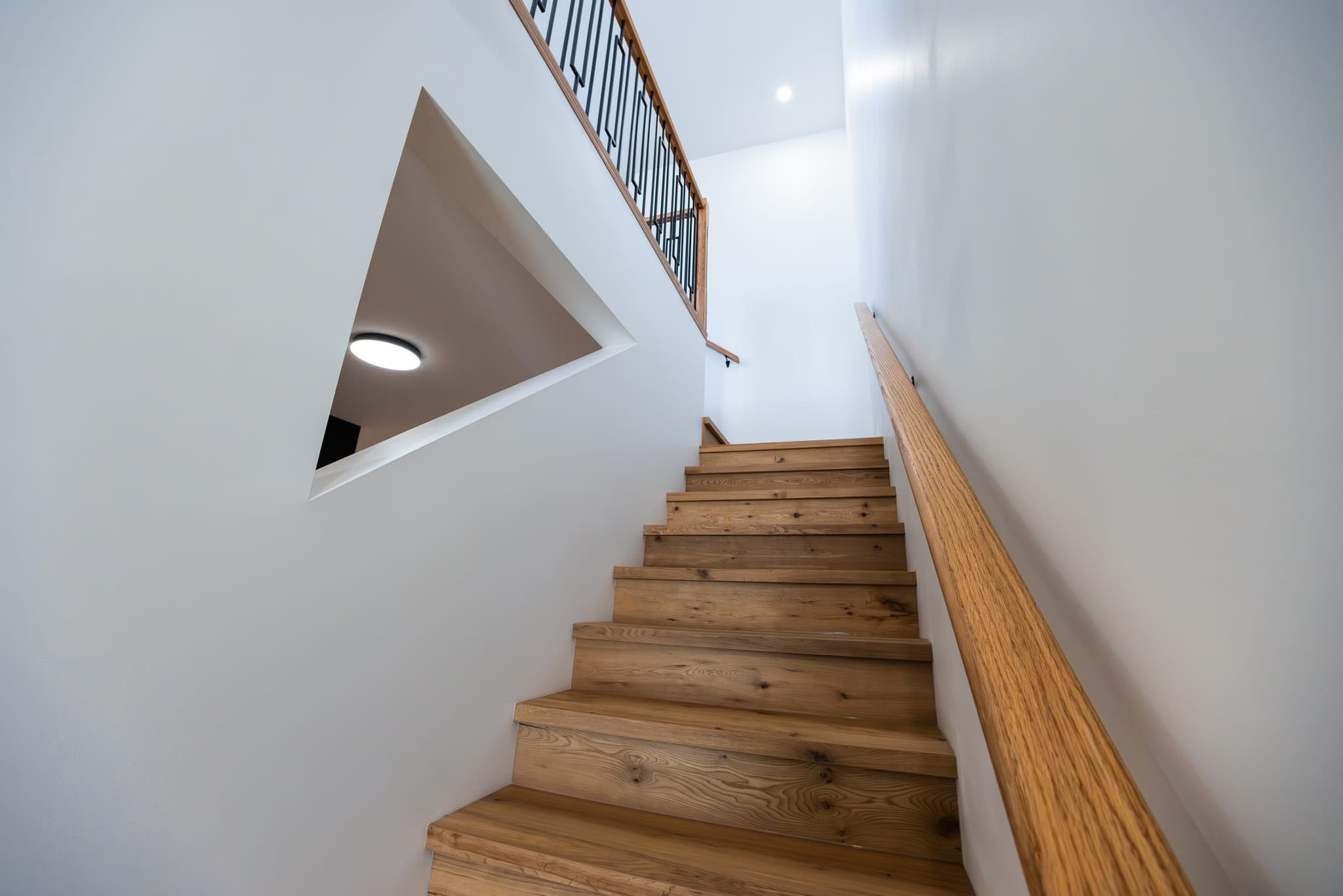 Custom white-oak staircase — design-forward build detail